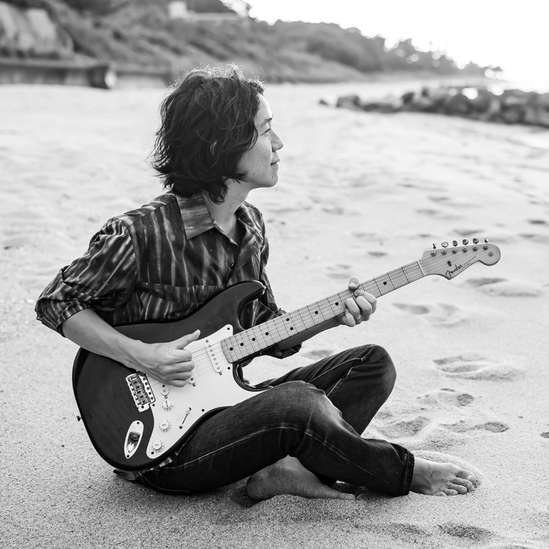 JP's PlayRoom playing guitar on the beach in Itoshima